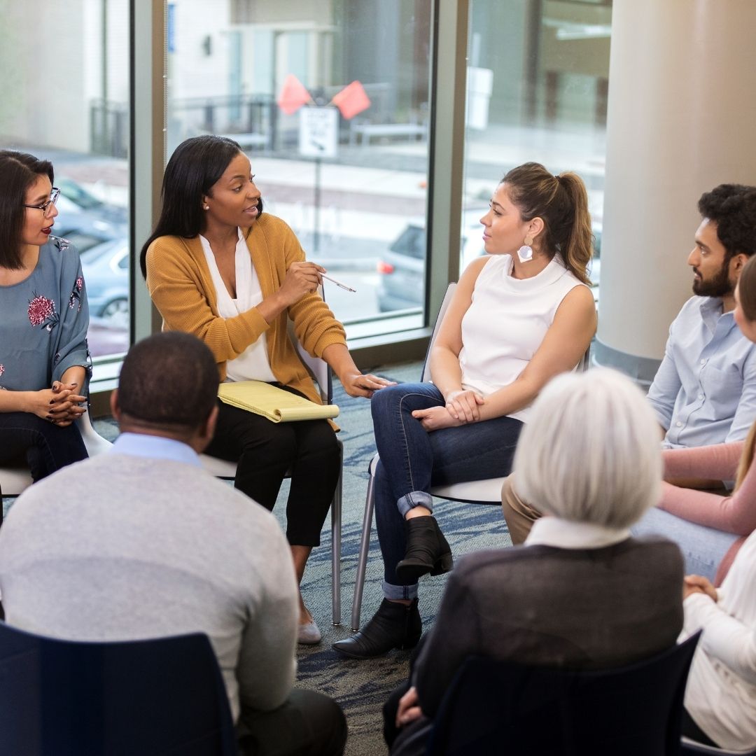 Woman leads group therapy with older adults