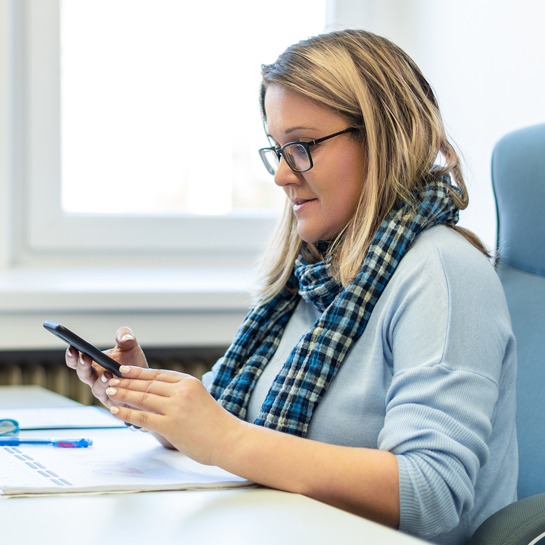 Therapist checking records on her phone