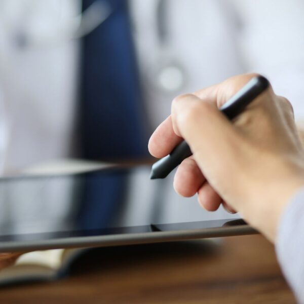 Patient signing form on tablet